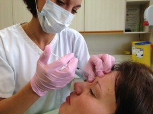 Joanne administering Botox to a patient