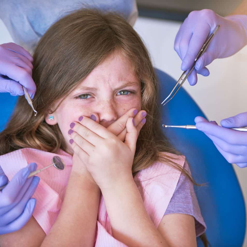 Young girl nervous at dentist