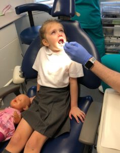 children's NHS treatment, Plymouth - a girl in the dentist's chair