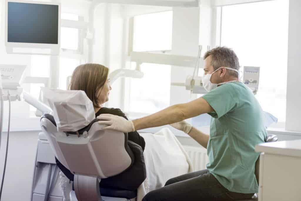 dentist and patient in chair