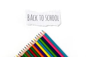 school pencils and a back to school sign don't show a mouth guard which is needed too