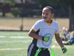 blue mouth guard or gum shield being worn by a young goalkeeper