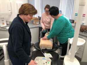 three staff monitoring dummy patient for life support SpaDental Plymouth