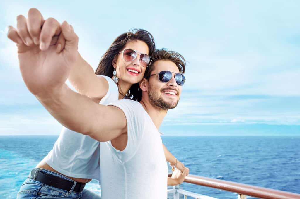relaxed couple at front of boat independent dental care smiles