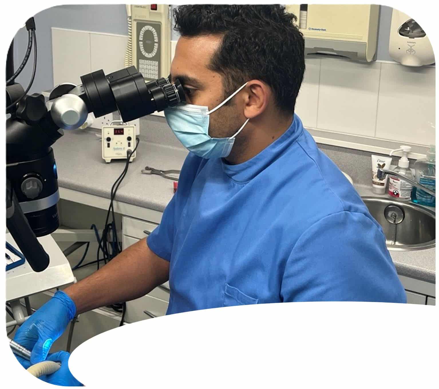 dentist using microscope for endodontic treatment