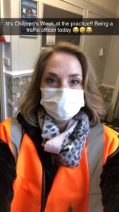 heather in facemask directing traffic