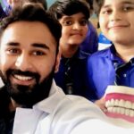 dentist with children for oral health education