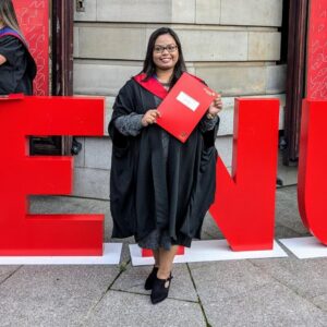 Trainee dental nurse holding red folder at Edinburgh Napier university